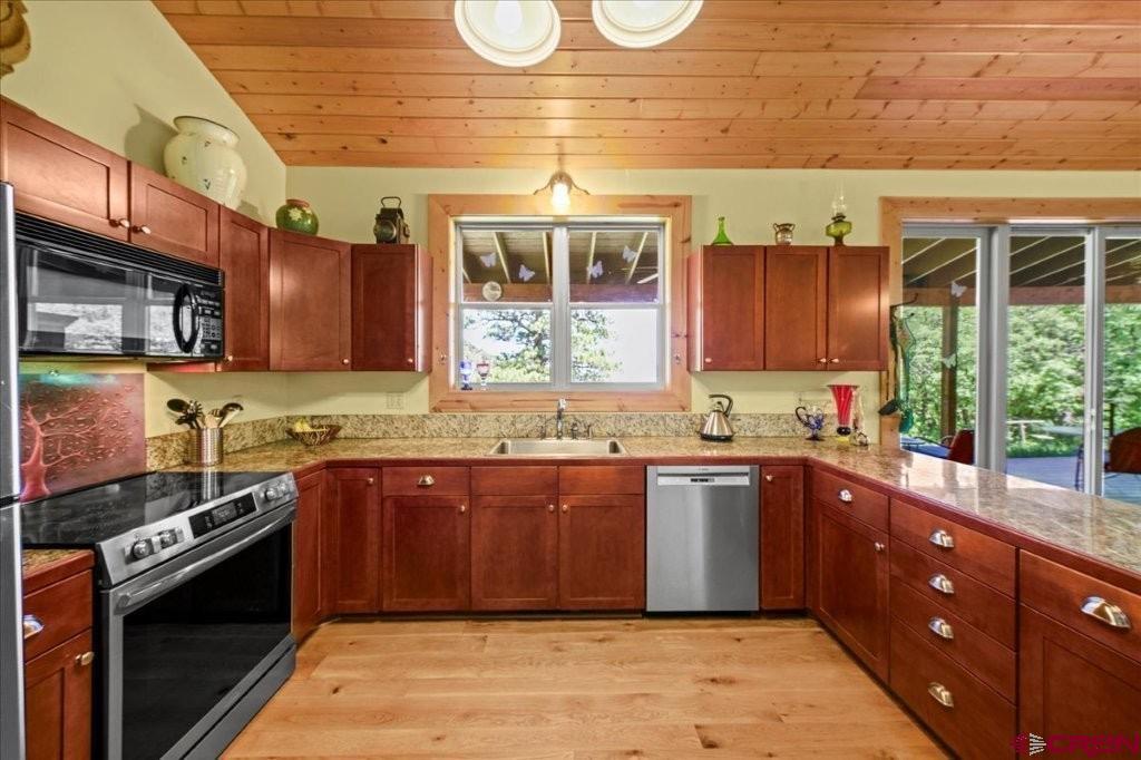 444 Which Way Ridgway, CO 81432 - Photo 13 of 36 a large kitchen with stainless steel appliances granite countertop a stove a sink and a microwave