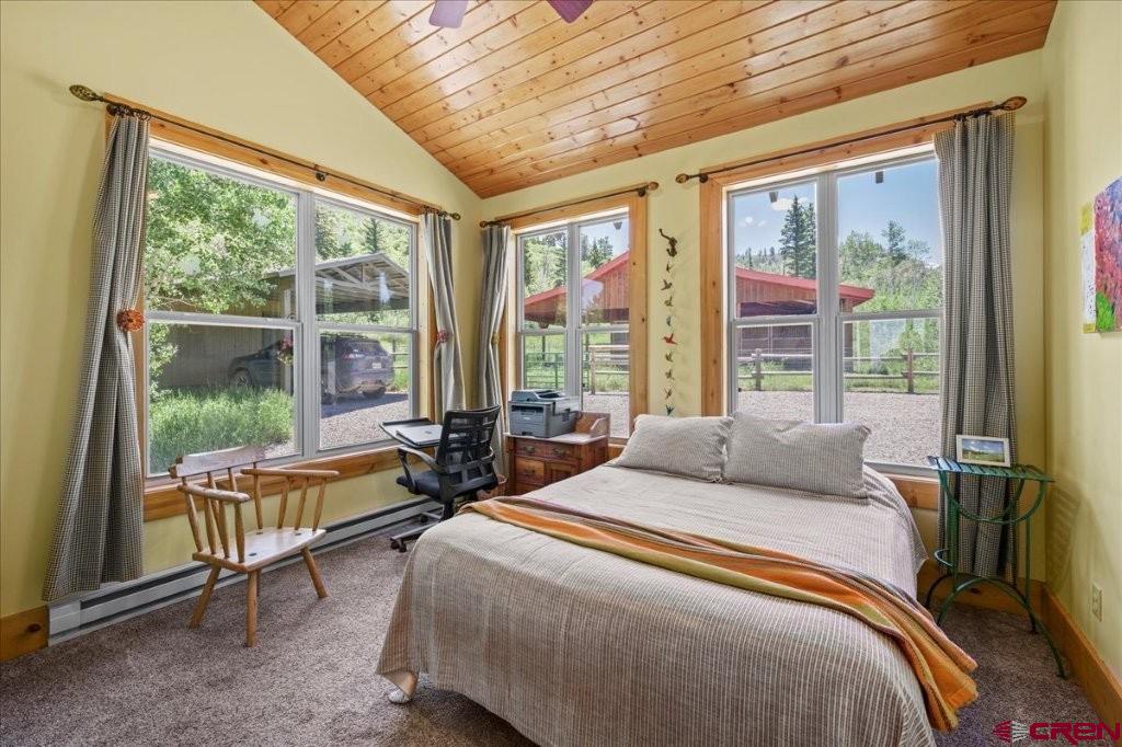 444 Which Way Ridgway, CO 81432 - Photo 14 of 36 a bedroom with furniture and a large window