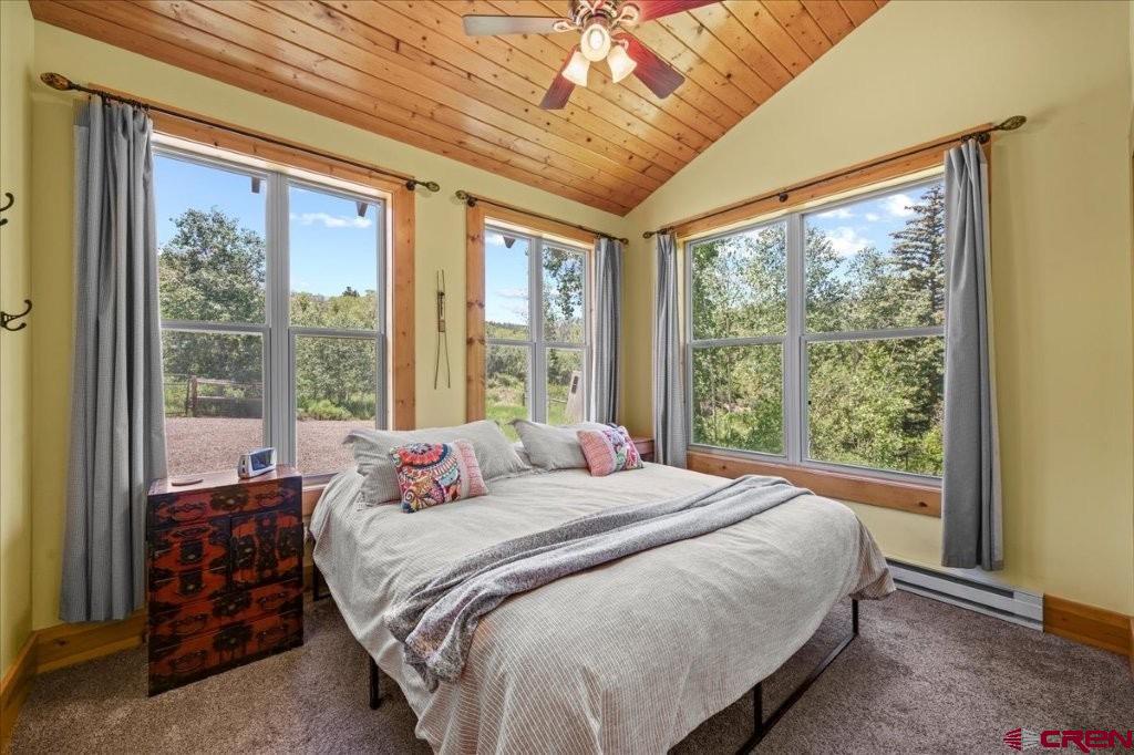 444 Which Way Ridgway, CO 81432 - Photo 16 of 36 a bedroom with a large bed and a large window