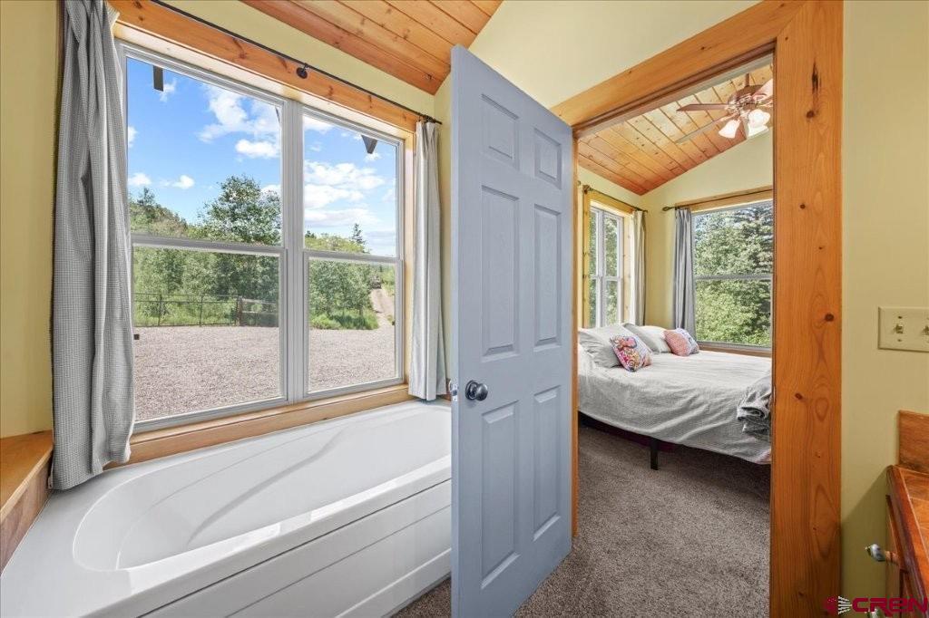 444 Which Way Ridgway, CO 81432 - Photo 17 of 36 a bedroom with a bed and a window