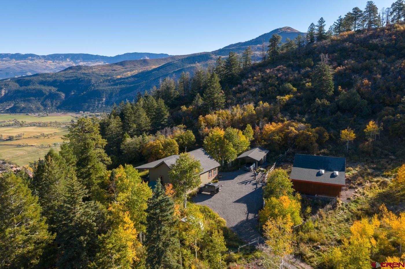 444 Which Way Ridgway, CO 81432 - Photo 3 of 36 a view of a lake with mountains in the background