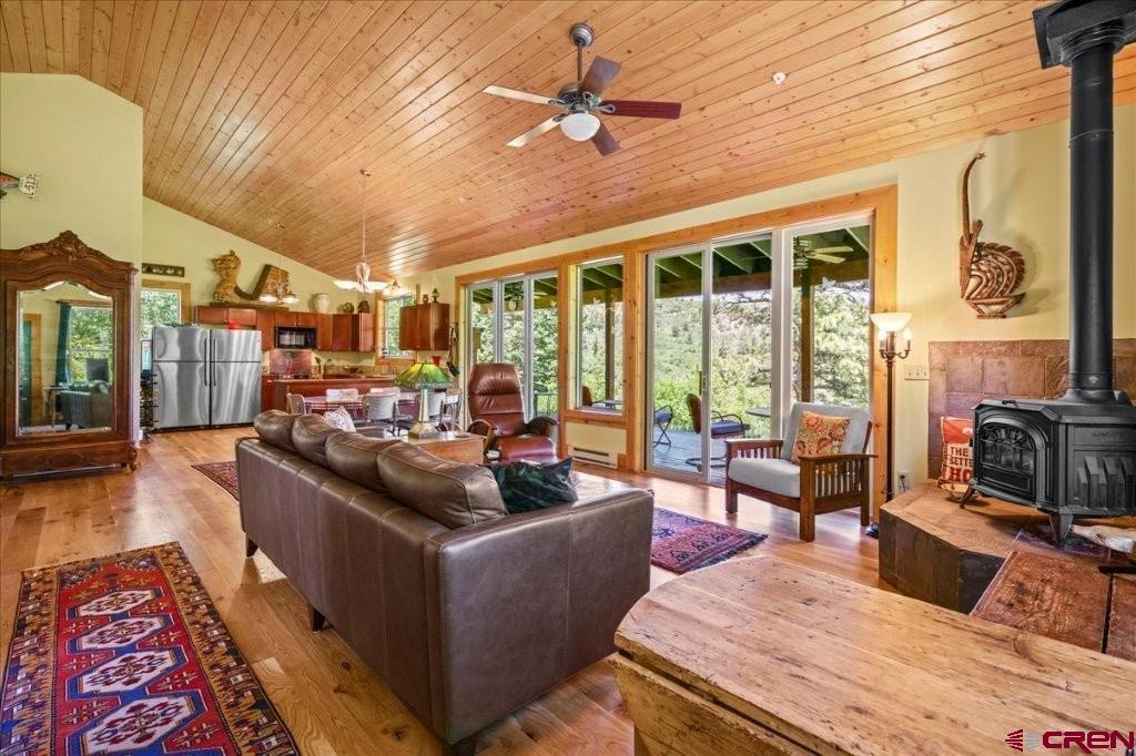 444 Which Way Ridgway, CO 81432 - Photo 9 of 36 a living room with furniture fireplace and a large window