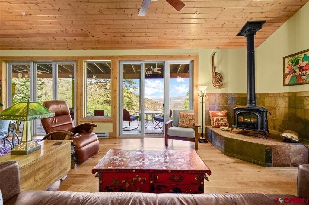444 Which Way Ridgway, CO 81432 - Photo 10 of 36 a living room with furniture and a floor to ceiling window