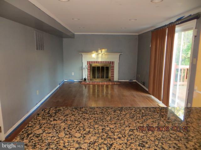 6923 Pinecrest Road Baltimore, MD 21228 - Photo 5 of 14 wooden floor in an empty room with a window