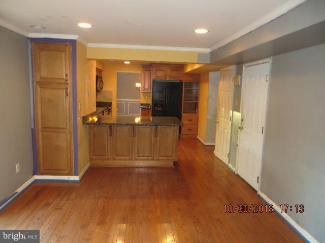 6923 Pinecrest Road Baltimore, MD 21228 - Photo 6 of 14 a view of a hallway with wooden shelves
