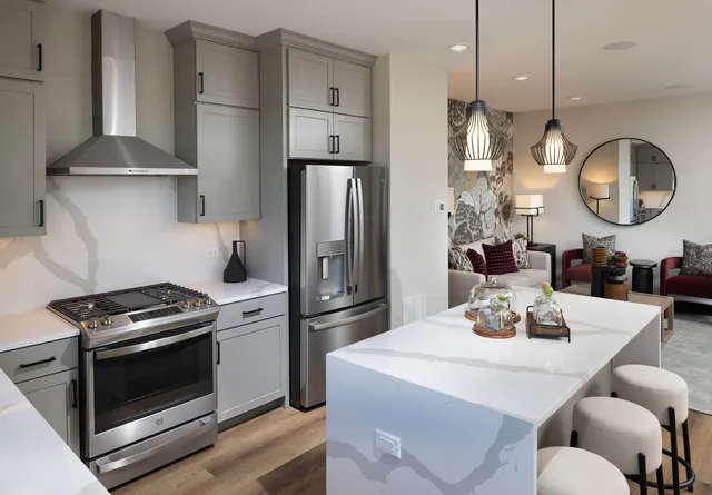 a kitchen with stainless steel appliances a refrigerator a stove a sink and a refrigerator