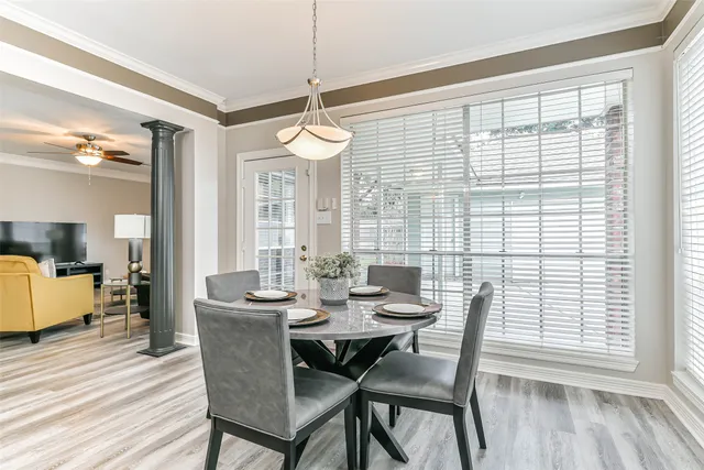 a view of a dining room with furniture window and wooden floor
