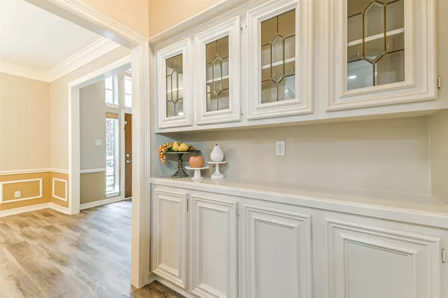 a kitchen with stainless steel appliances white cabinets and a window