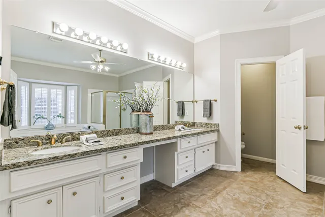a spacious bathroom with a granite countertop sink a mirror and a