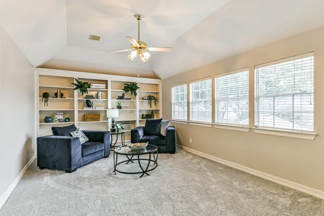 a view of a livingroom with workspace and a window