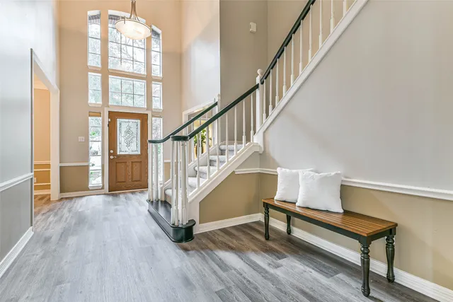 a view of entryway and hall with wooden floor