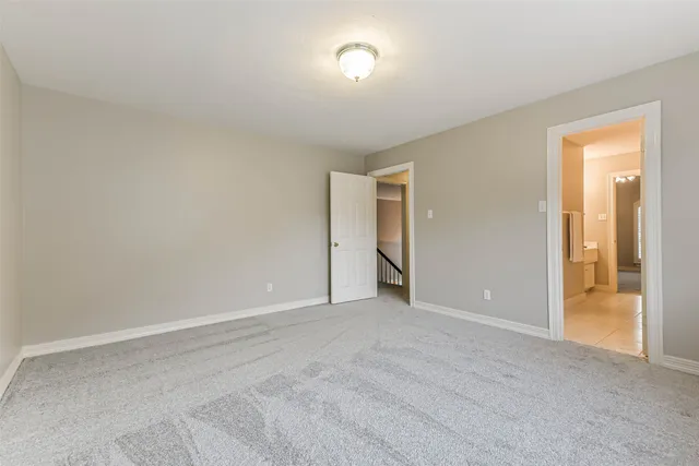 a view of an empty room and a window