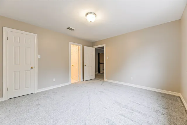 a view of an empty room and a window