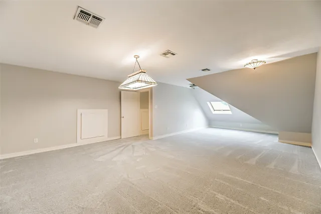 a view of empty room with a chandelier fan and window