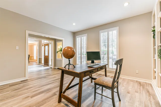 a view of a workspace room with furniture and wooden floor