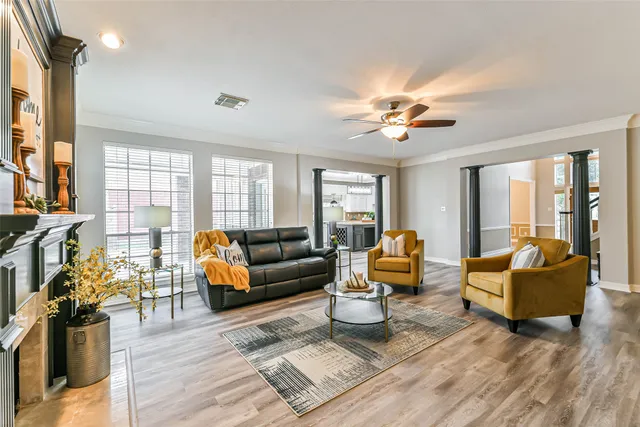 a living room with furniture fireplace and a large window