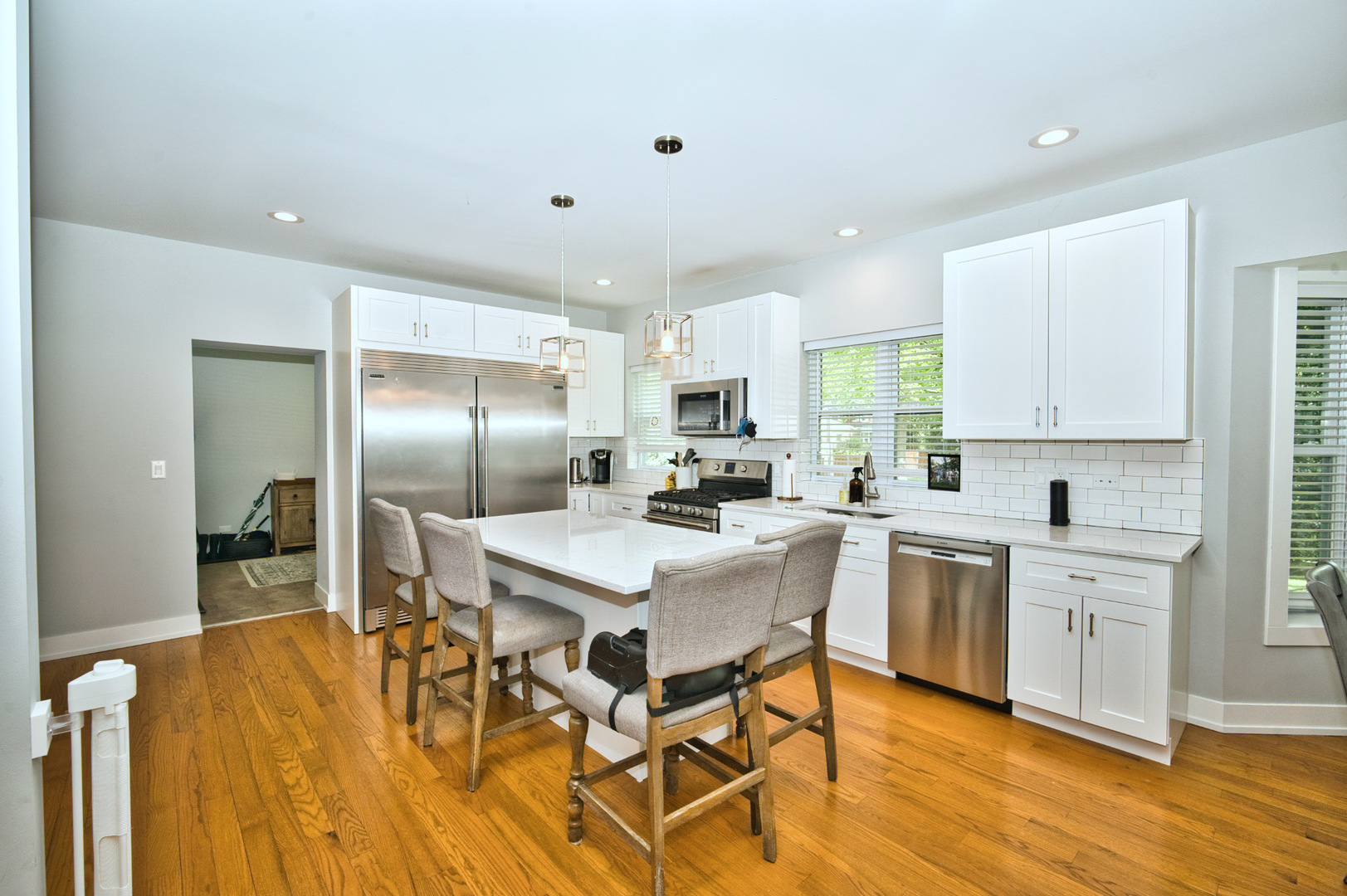 643 Oriole Avenue Park Ridge, IL 60068 - Photo 12 of 31 a kitchen with stainless steel appliances kitchen island granite countertop a sink a stove a dining table and chairs