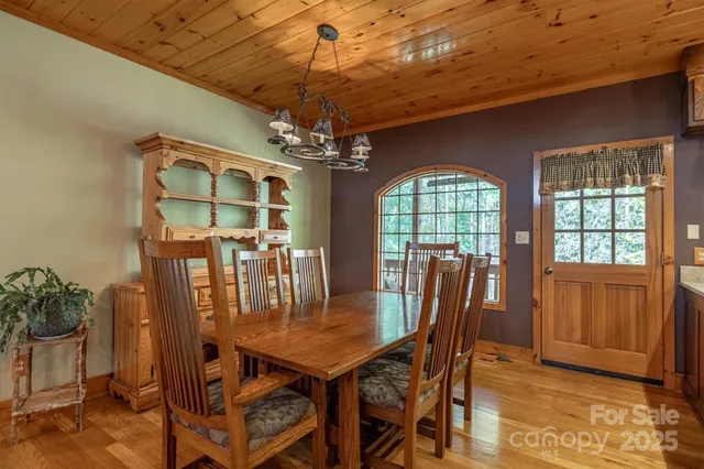 a dining room with furniture a chandelier and window