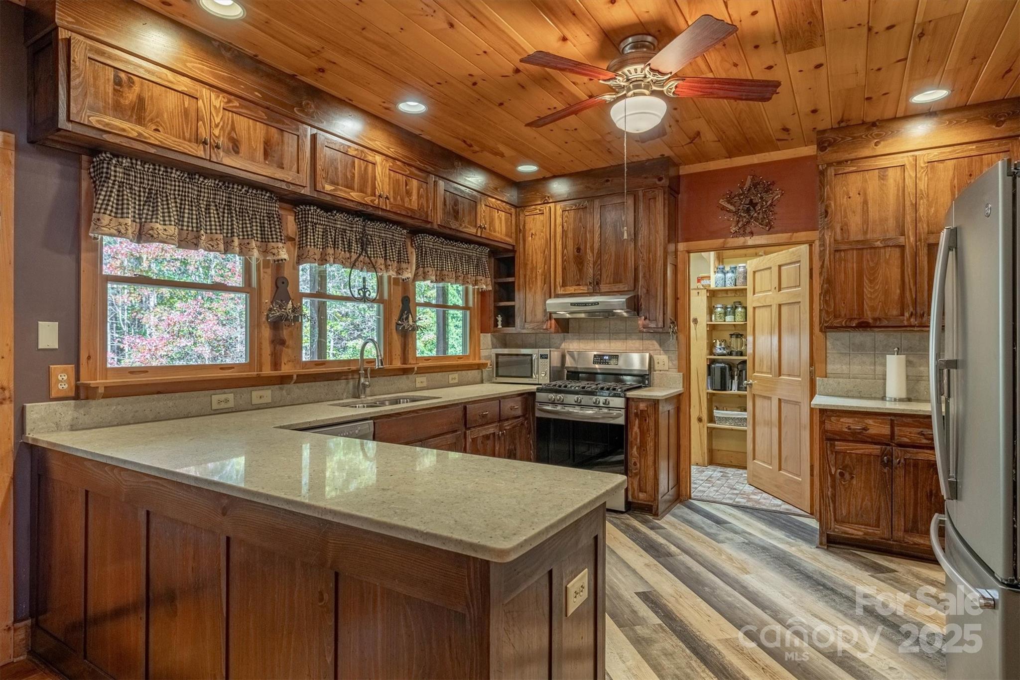 4030 South View Boulevard Morganton, NC 28655 - Photo 15 of 43 a kitchen with a stove a refrigerator and a sink
