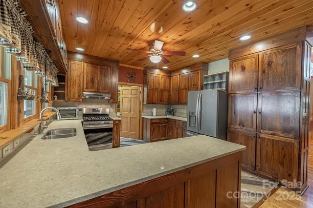 a kitchen with stainless steel appliances a refrigerator and a stove