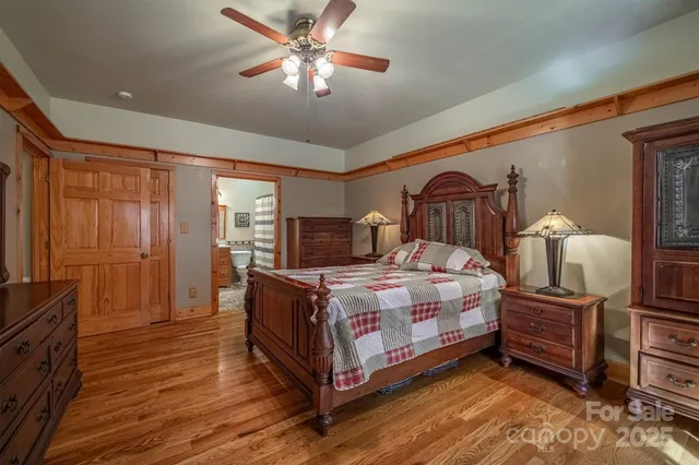 a bedroom with a bed lamp on dresser and a chandelier