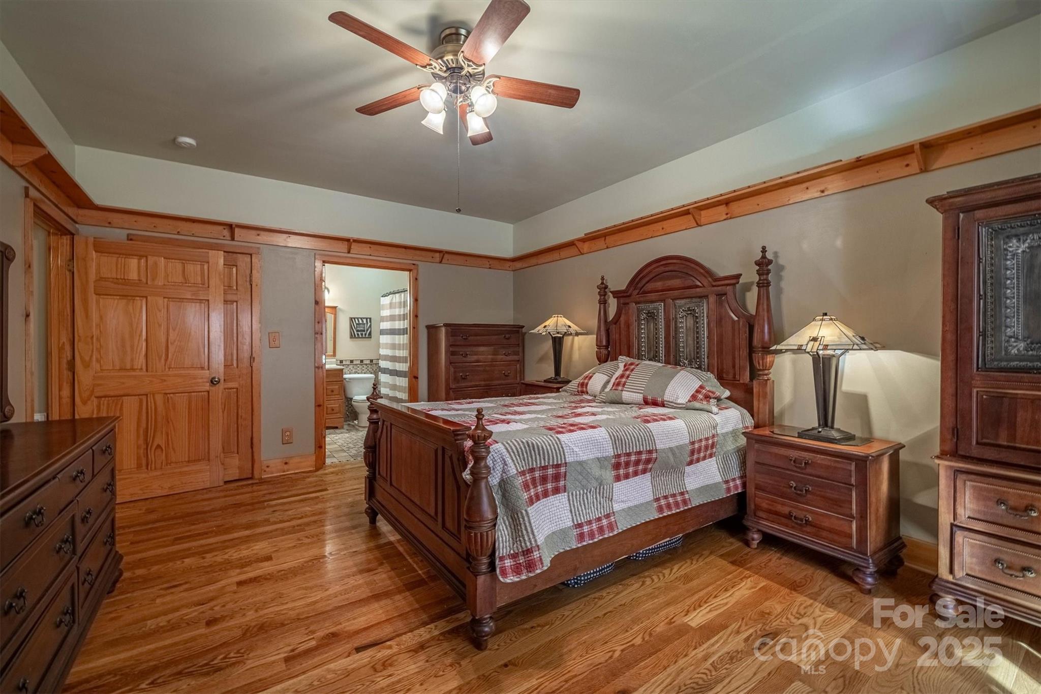 4030 South View Boulevard Morganton, NC 28655 - Photo 19 of 43 a bedroom with a bed lamp on dresser and a chandelier