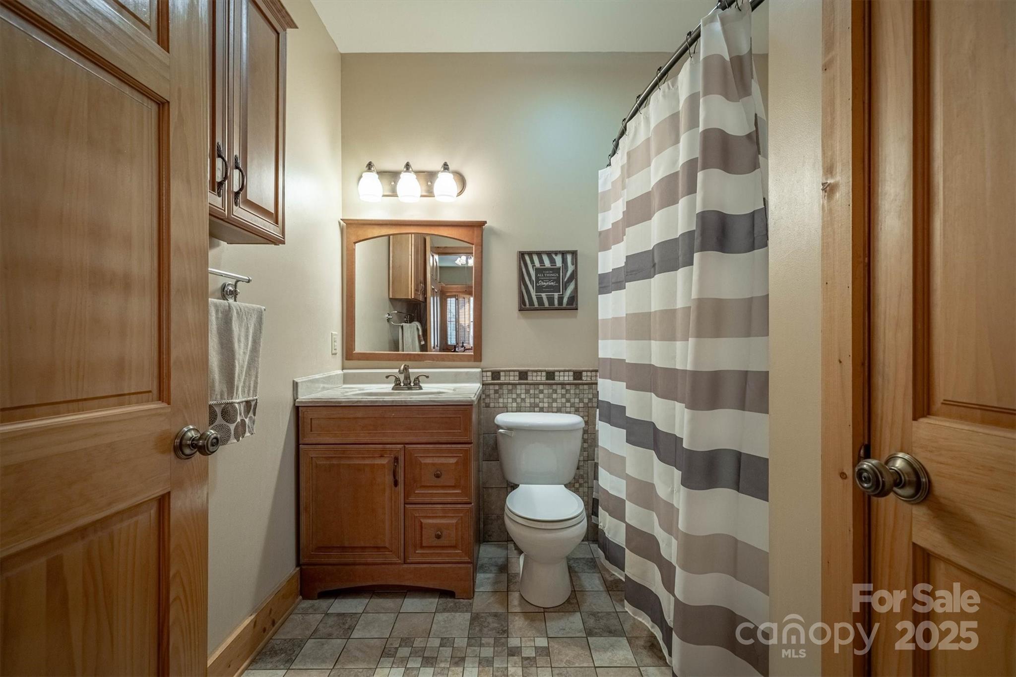 4030 South View Boulevard Morganton, NC 28655 - Photo 20 of 43 a bathroom with a granite countertop sink toilet a mirror and shower