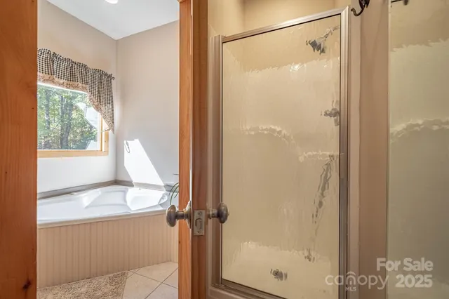 a bathroom with a shower and a tub