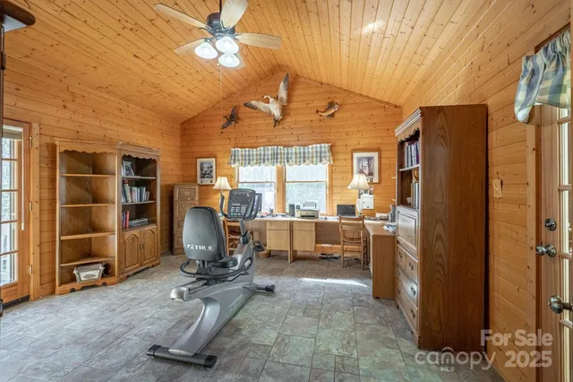 a view of a livingroom with workspace and a window