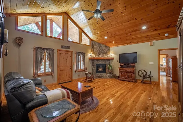 a living room with furniture a fireplace and a flat screen tv