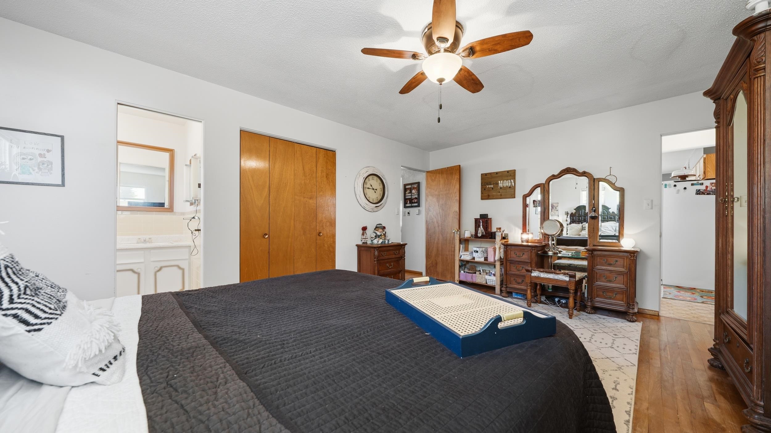 3445 C C 1/2 Road Palisade, CO 81526 - Photo 14 of 37 a bed room with a bed mirror and a chandelier