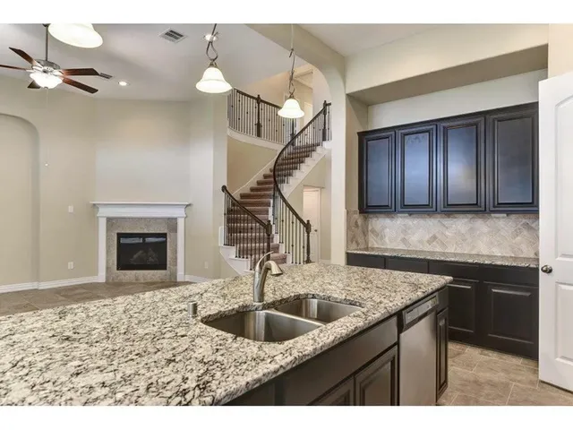 a kitchen with sink cabinets and chandelier