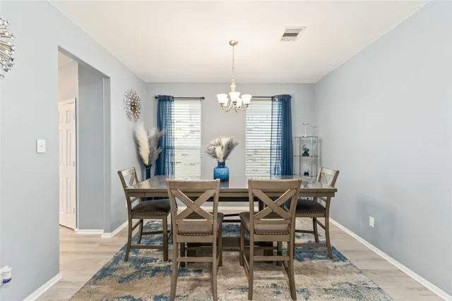 a view of a dining room with furniture and window