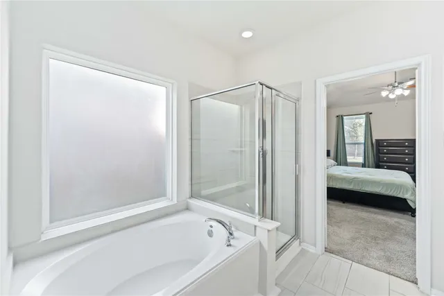 a bathroom with a tub and a shower