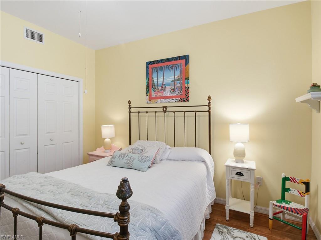 20161 Bravada Street, Unit 2 Estero, FL 33928 - Photo 20 of 33 a bedroom with a bed and a table in it