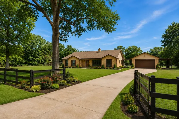 a front view of a house with a yard and potted plants