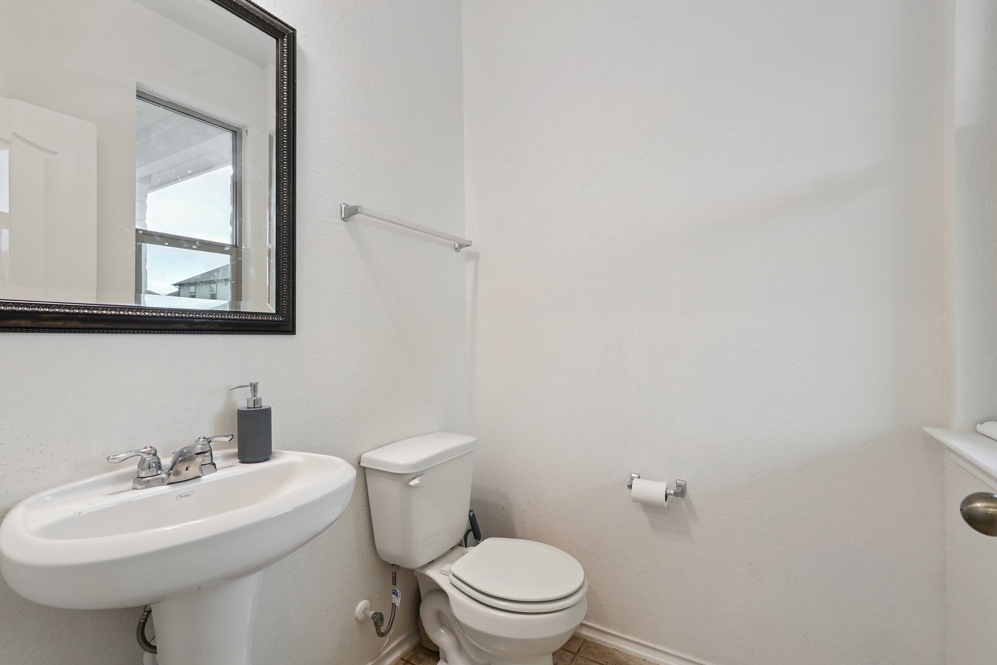 13817 Eleanor Roosevelt Street Manor, TX 78653 - Photo 12 of 35 a bathroom with a sink a toilet and mirror