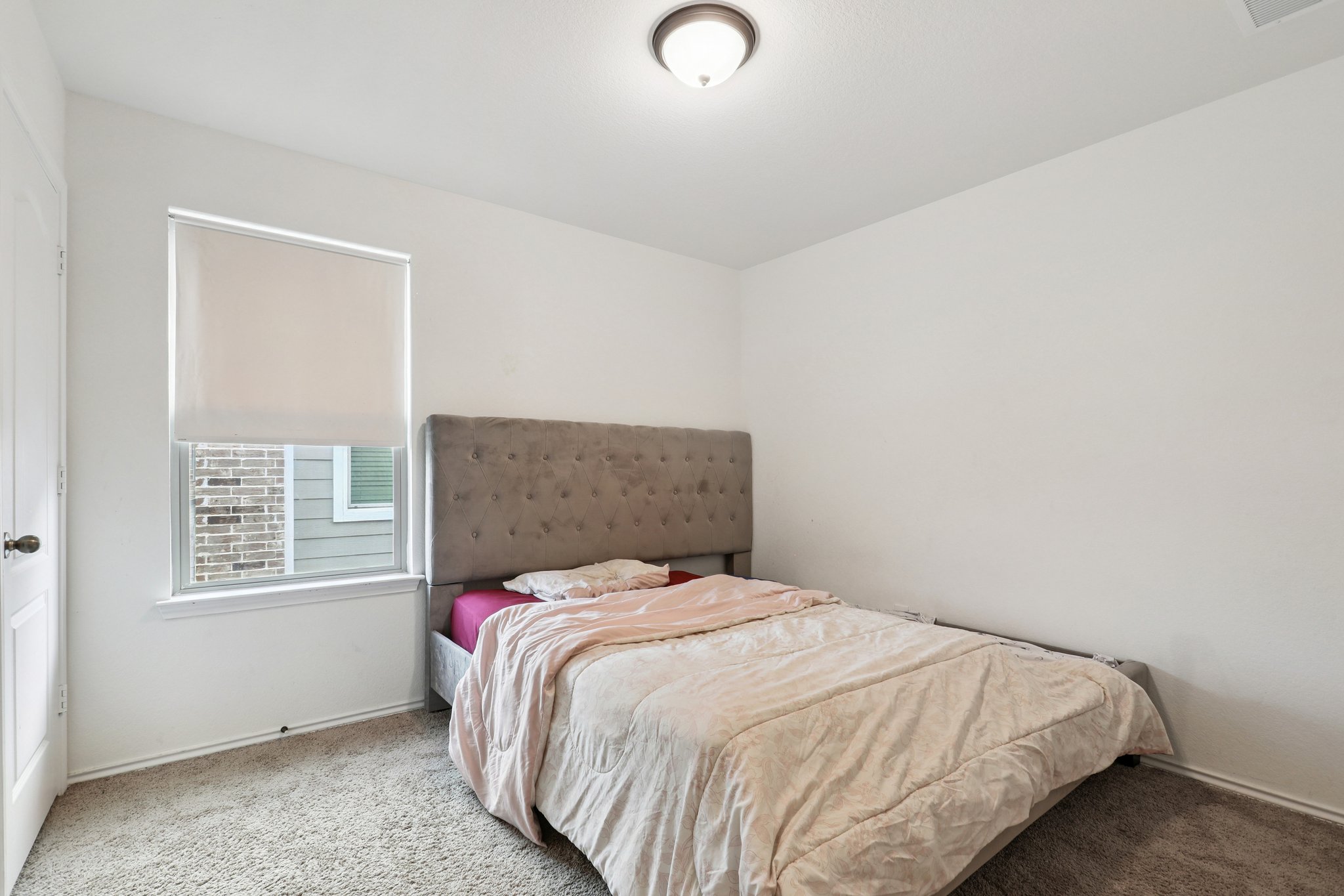 13817 Eleanor Roosevelt Street Manor, TX 78653 - Photo 18 of 35 a bedroom with a bed and a window