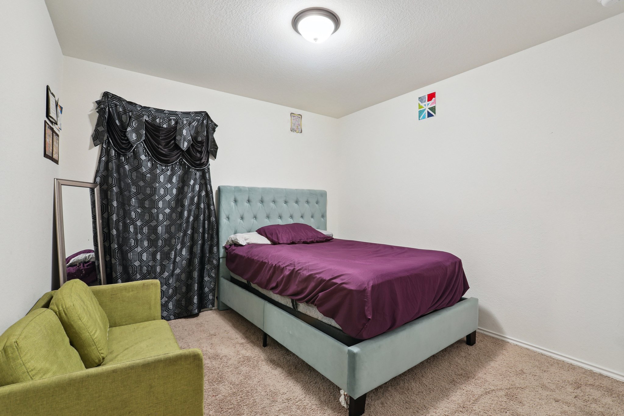 13817 Eleanor Roosevelt Street Manor, TX 78653 - Photo 20 of 35 a spacious bedroom with a bed and a couch