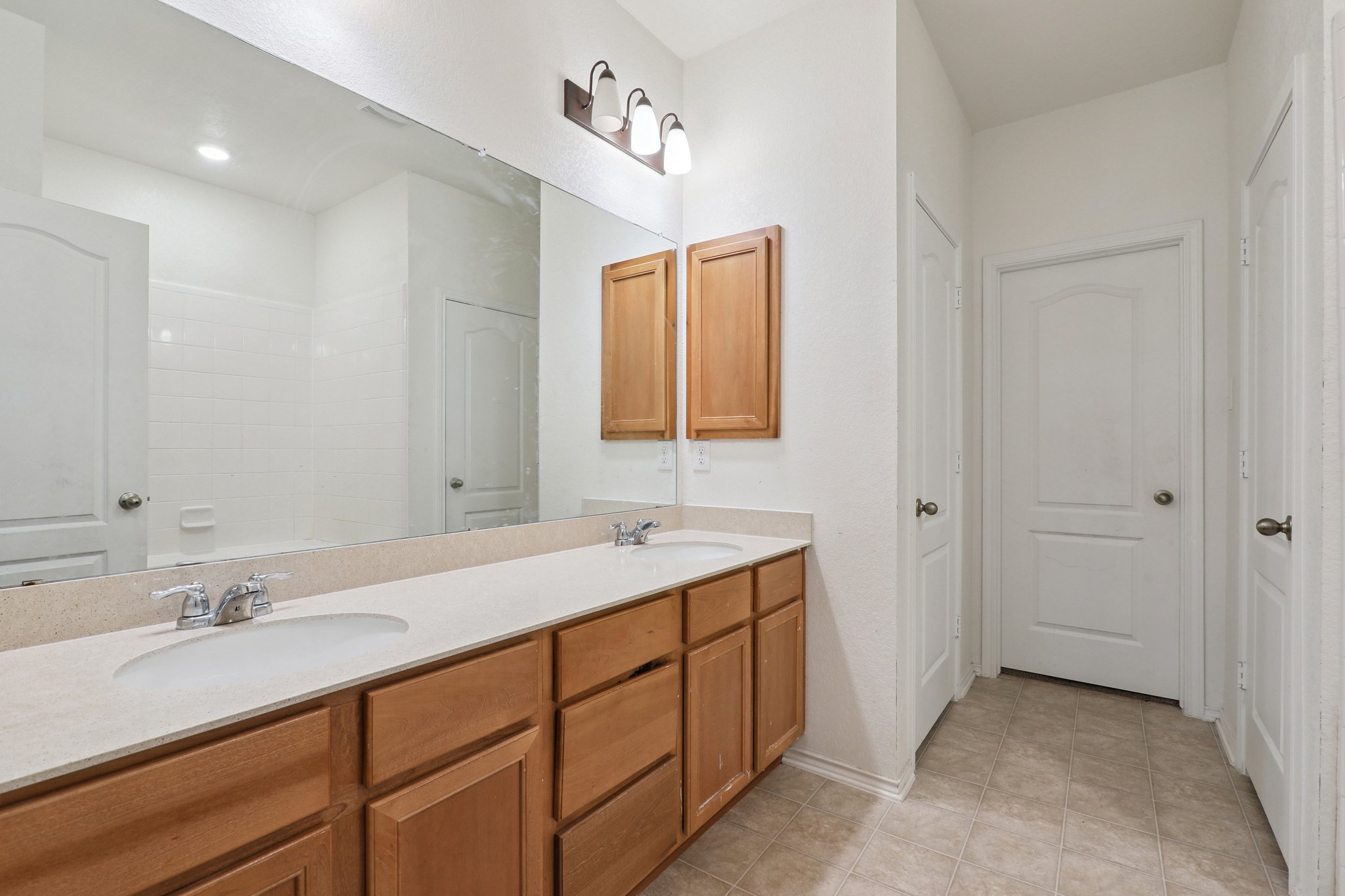 13817 Eleanor Roosevelt Street Manor, TX 78653 - Photo 27 of 35 a bathroom with a sink and a mirror