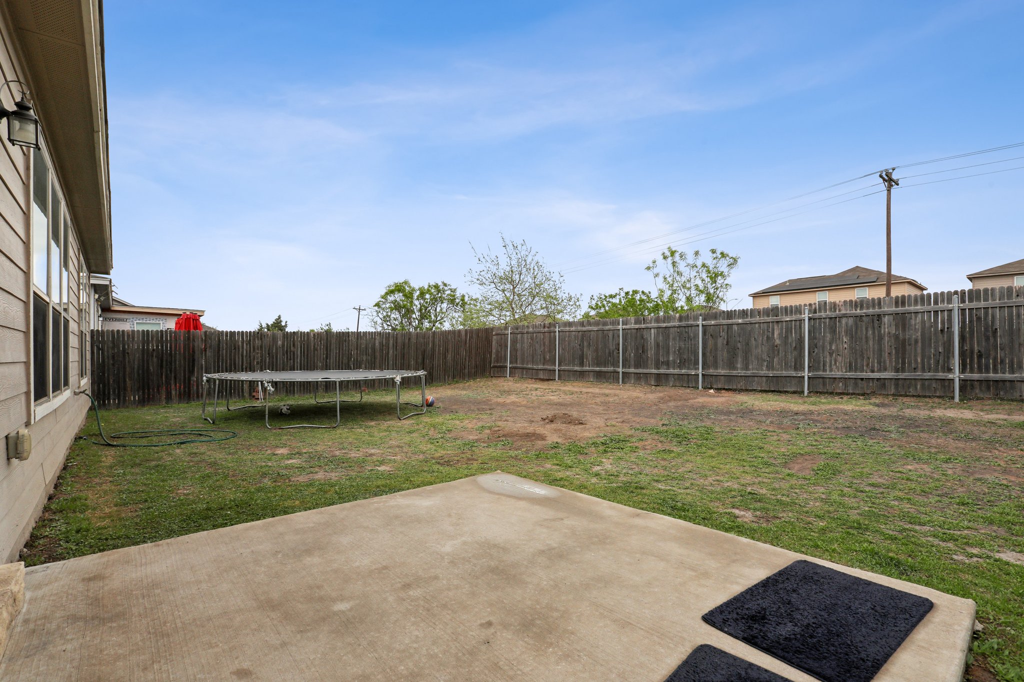 13817 Eleanor Roosevelt Street Manor, TX 78653 - Photo 30 of 35 a view of a garden with wooden fence