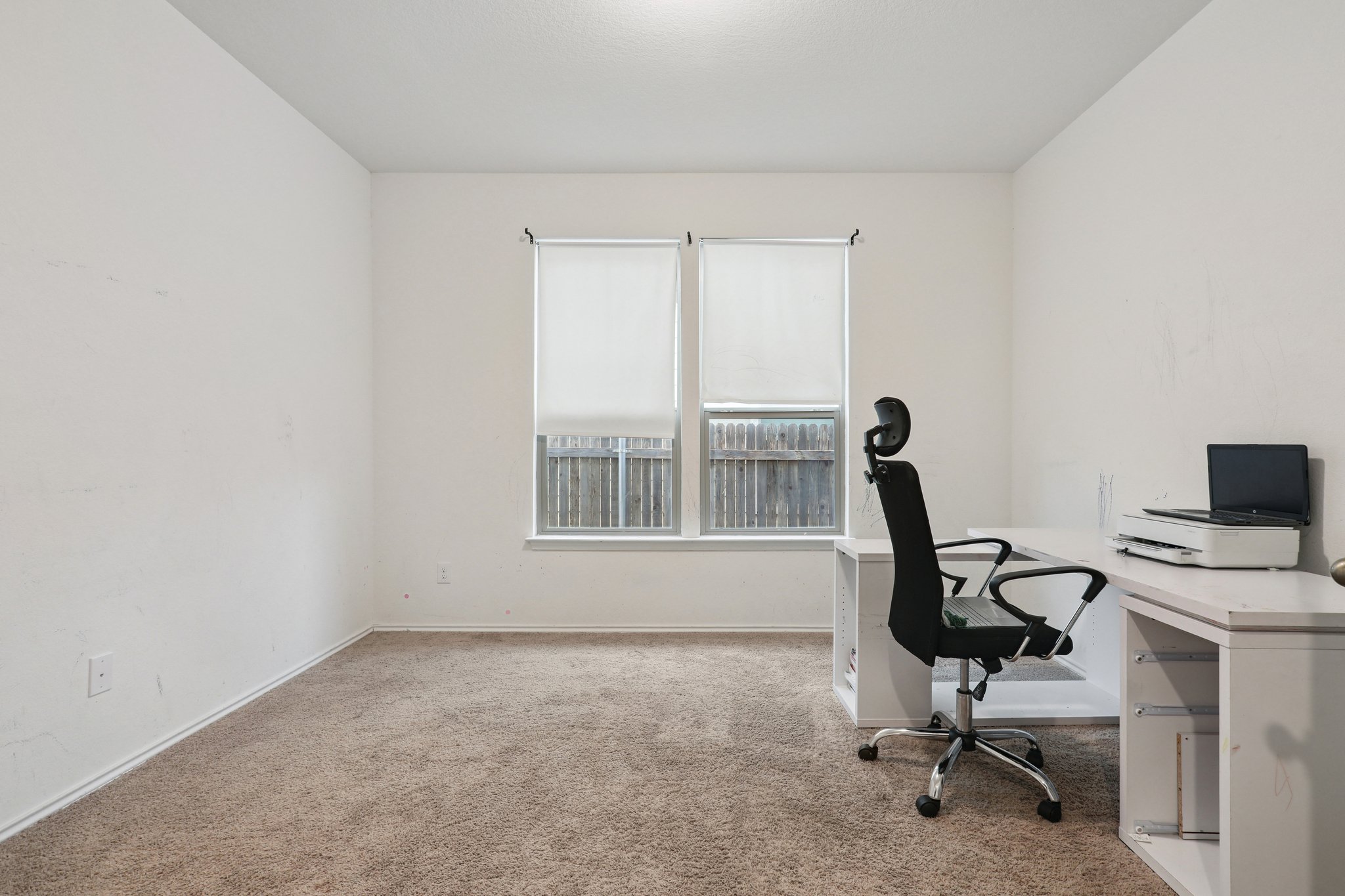 13817 Eleanor Roosevelt Street Manor, TX 78653 - Photo 4 of 35 a view of a workspace with furniture and a window