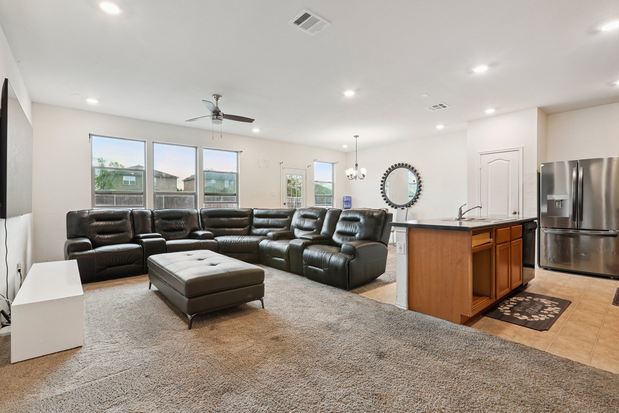 13817 Eleanor Roosevelt Street Manor, TX 78653 - Photo 7 of 35 a living room with furniture a large window and gym equipment