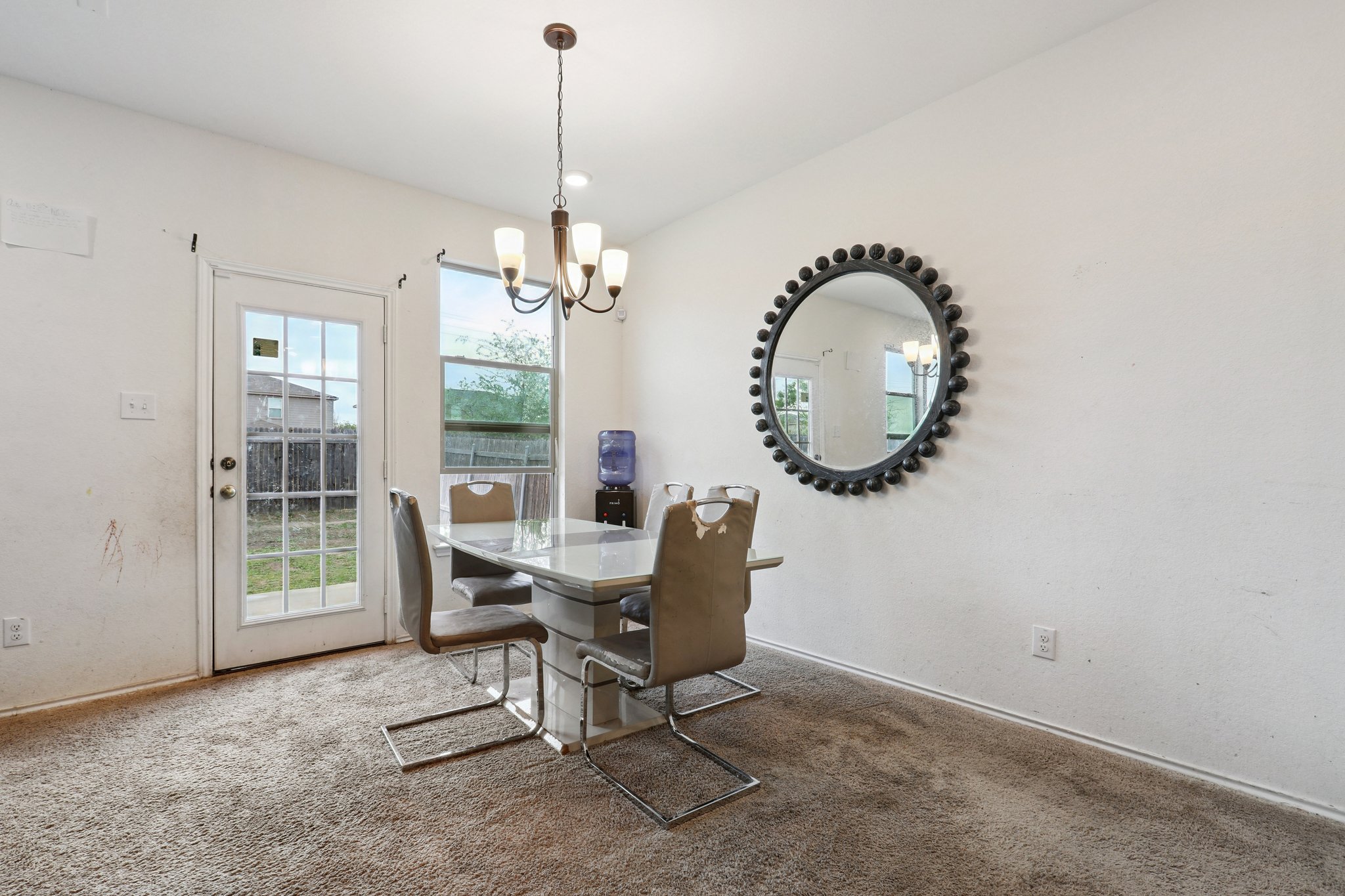 13817 Eleanor Roosevelt Street Manor, TX 78653 - Photo 8 of 35 a living room with furniture and a chandelier