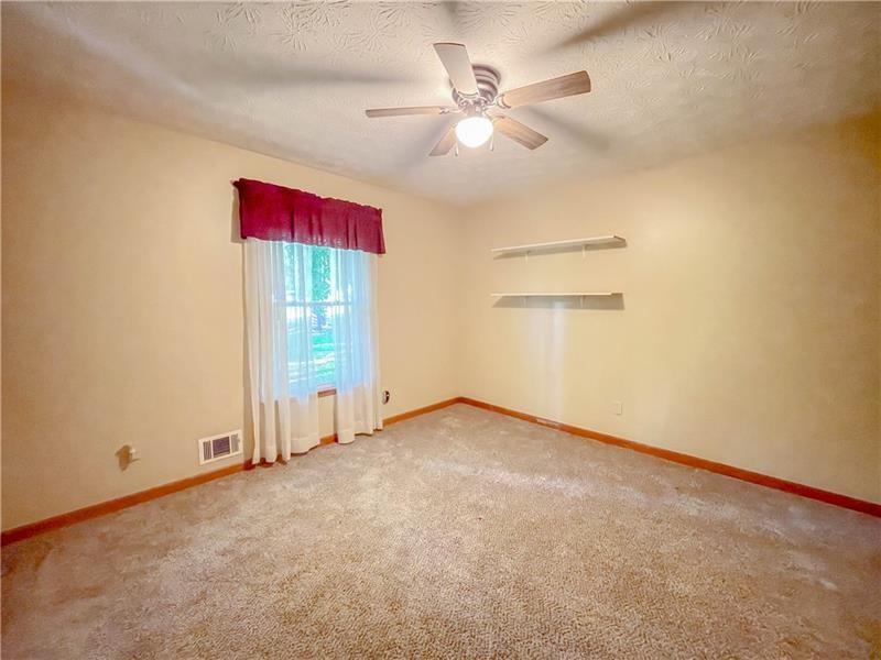 111 Libby Lane Stockbridge, GA 30281 - Photo 15 of 30 an empty room with a ceiling fan and a window