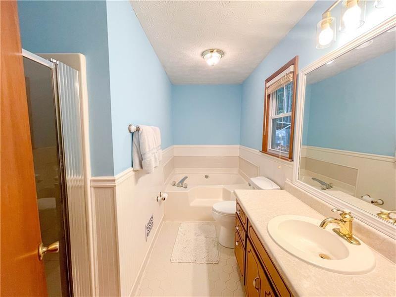 111 Libby Lane Stockbridge, GA 30281 - Photo 21 of 30 a spacious bathroom with a double vanity sink and a mirror