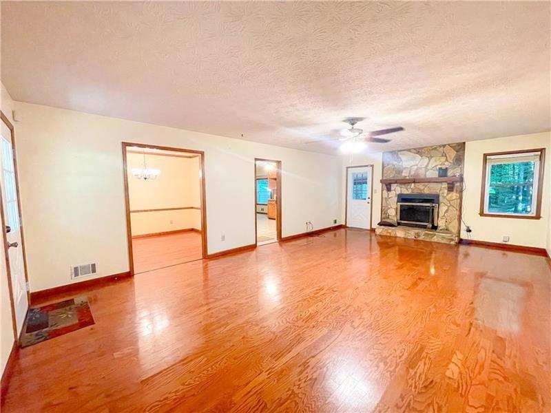 111 Libby Lane Stockbridge, GA 30281 - Photo 5 of 30 wooden floor fireplace and natural light in room