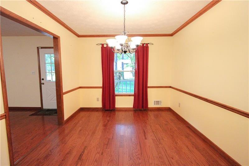 111 Libby Lane Stockbridge, GA 30281 - Photo 8 of 30 a view of an empty room with wooden floor and a window