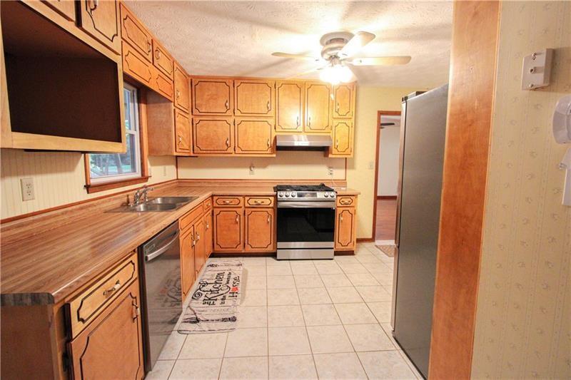 111 Libby Lane Stockbridge, GA 30281 - Photo 10 of 30 a kitchen with stainless steel appliances granite countertop a stove a sink and a refrigerator