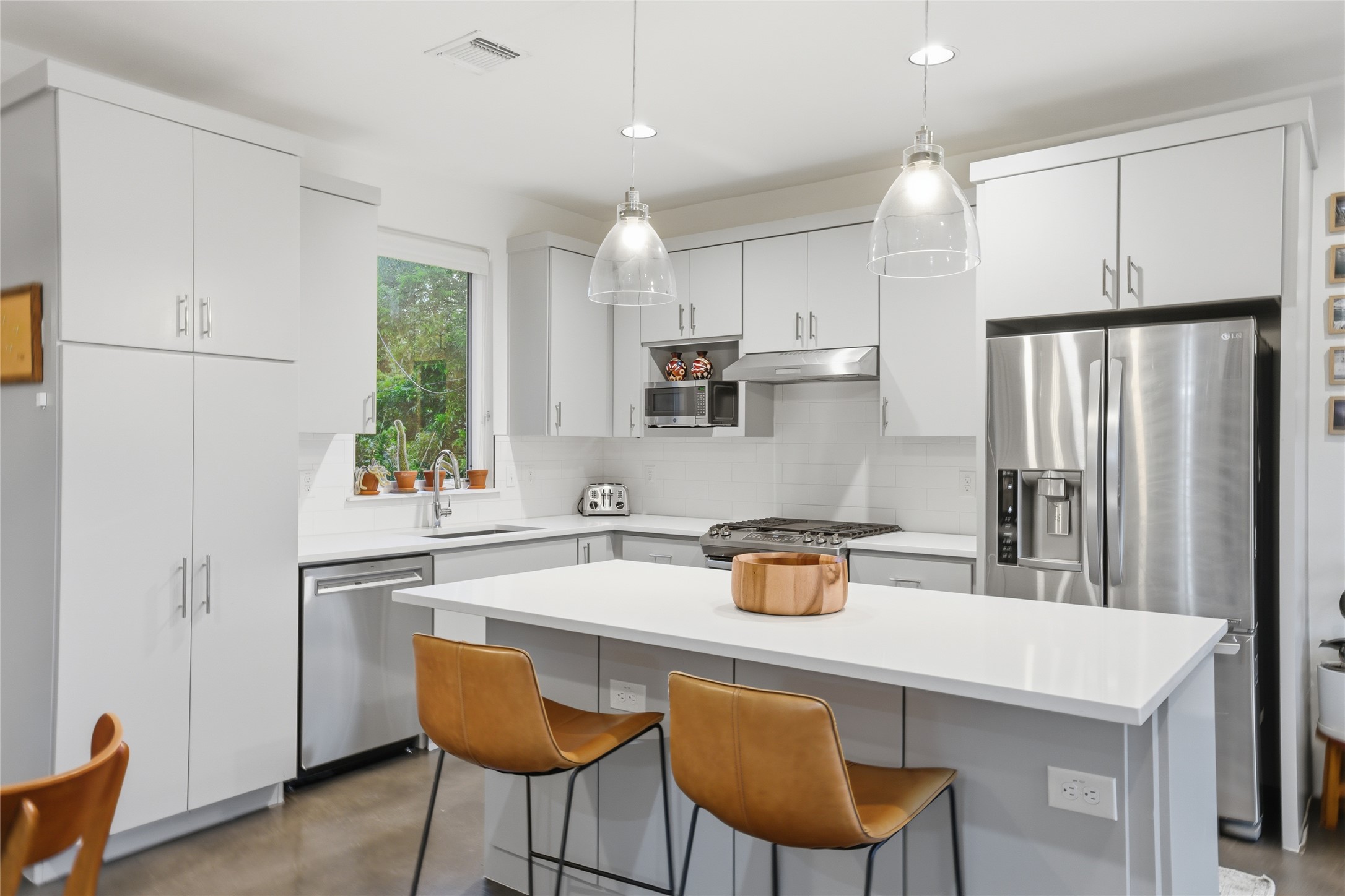1709 Perez Street, Unit 2 Austin, TX 78721 - Photo 18 of 33 Culinary delights await in this modern kitchen with sleek cabinetry and a functional island.